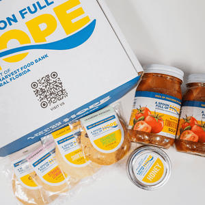 two jars of tomato basil soup, one 10oz jar of raw honey and four shortbread cookies with box from a spoon full of hope